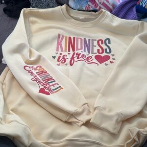 Pale yellow sweatshirt. Never worn.  From Hoodies For Heroes